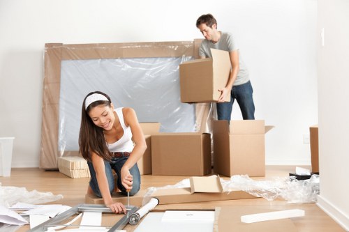 Moving team handling furniture safely with protective equipment
