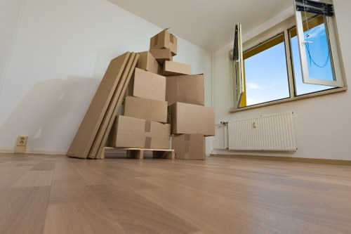 Moving team handling house removals in Mile End street setting
