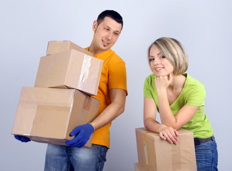 Packed moving boxes and furniture prepared for man and van service