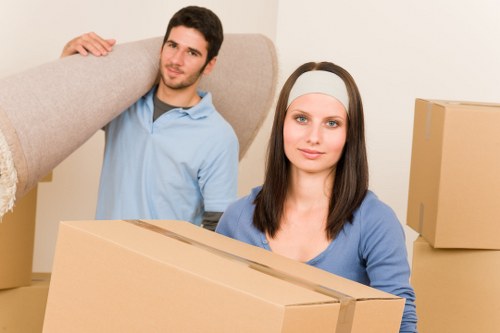 Loading furniture and boxes into a moving van in Mile End