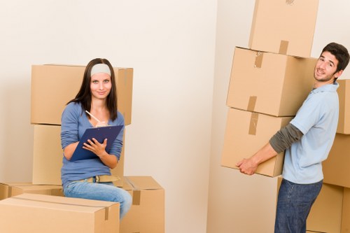 Prepared boxes and furniture ready for a moving truck in Mile End